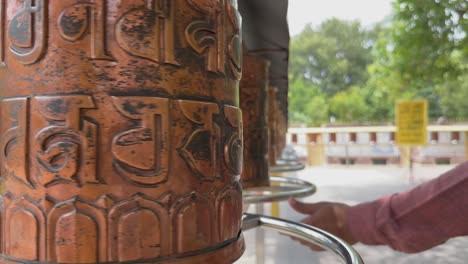a prayer wheel, or mani wheel, is a cylindrical wheel for buddhist recitation. the wheel is installed on a spindle made from metal, wood, stone, leather