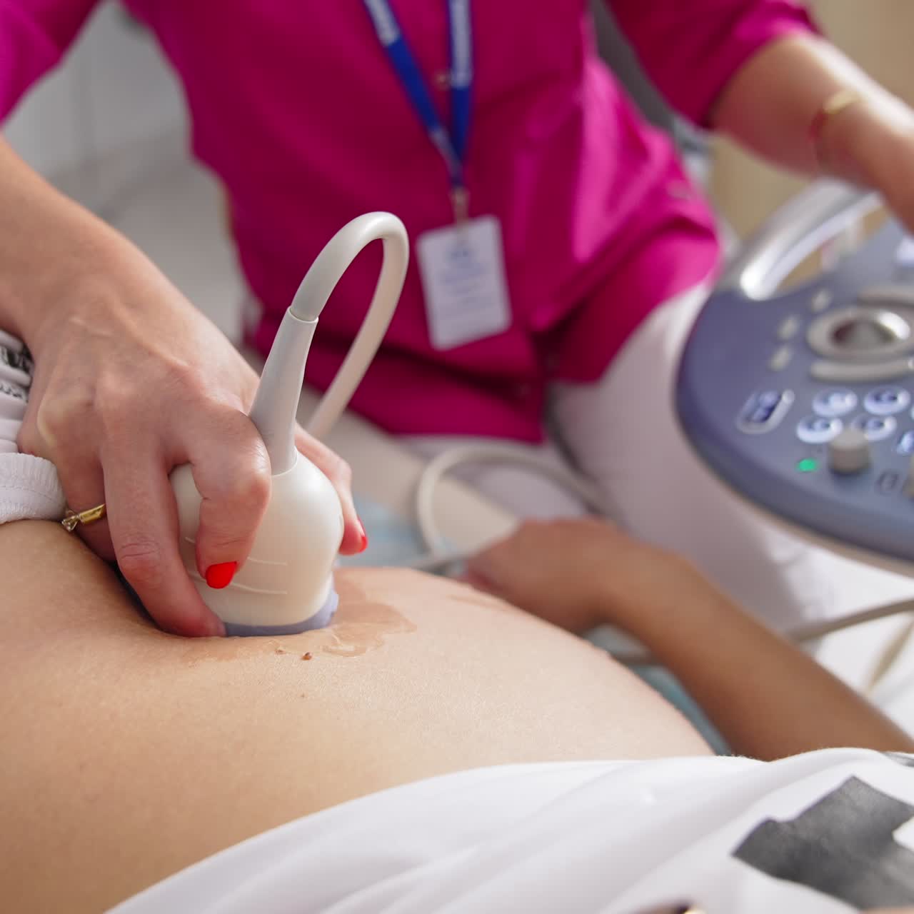 Young pregnant woman getting ultrasound from female doctor in clinic. Pregnancy and Healthcare concept. Prenatal Screening