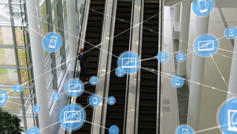 Digital communication icons animation over people on escalators in modern building