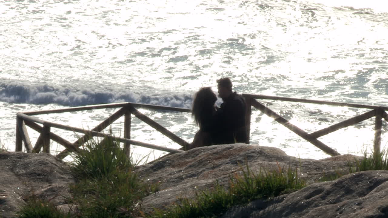 Young couple take a photo at Cape Mondego viewpoint.