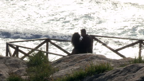 young couple take a photo at cape mondego viewpoint.