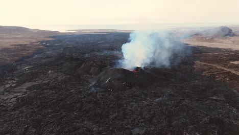 Black-volcanic-landscape-with-smoking-volcano-crater-eruption,-Iceland