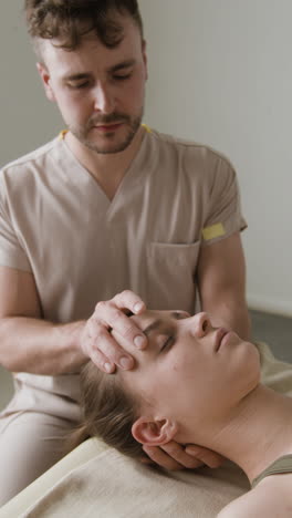 chiropractic or therapy session: practitioner treating a patient's head and neck
