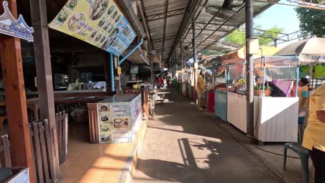 walking down a lively outdoor market aisle