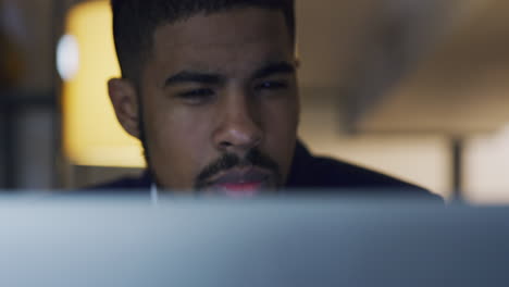 young-businessman-using-a-computer-during-a-late