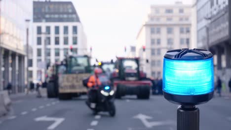 Blinking-motorcycle-police-light-during-manifestation-while-colleague-slaloms-on-the-city-road---Brussels,-Belgium