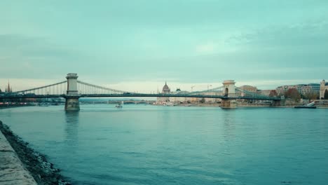 a still image of the chain bridge and its traffic near the shore