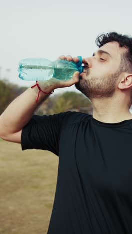 athlete refreshes with water after a hard workout