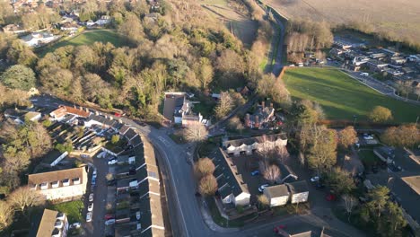 bury st edmunds in england, showing residential area with roads and trees, golden hour, aerial view