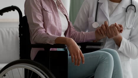 doctor supporting a patient in a wheelchair