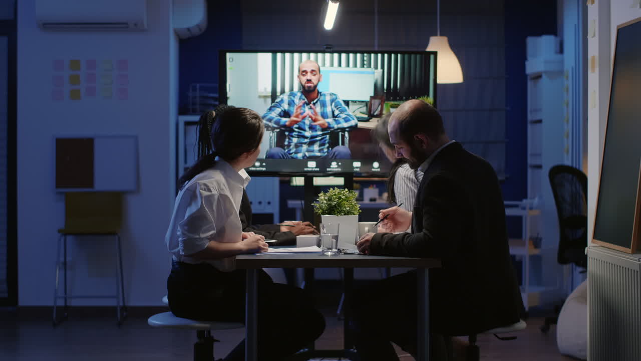 Multi ethnic businesspeople discussing with remote entrepreneur in wheelchair during online videocall