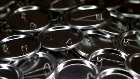 stack of pin badge button workpieces on rotating table