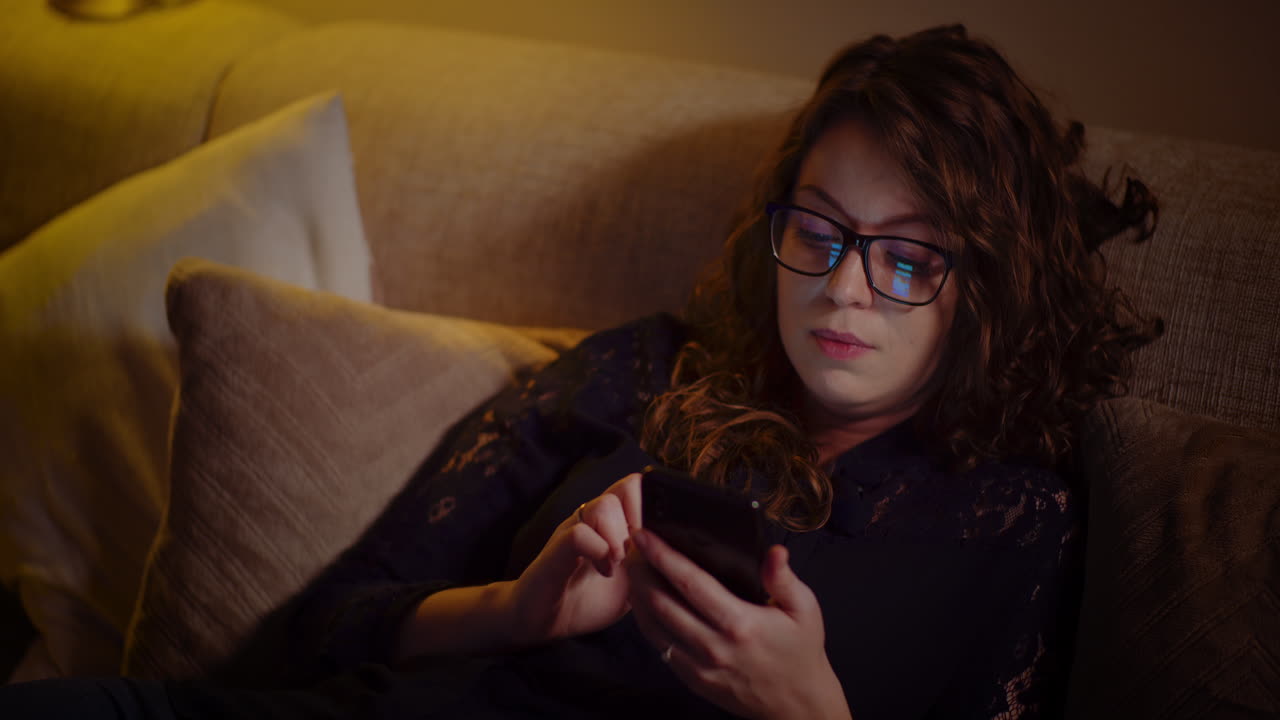 Woman using phone on couch