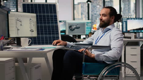 man with paraplegia in inclusive rd office designs green technology solar panels