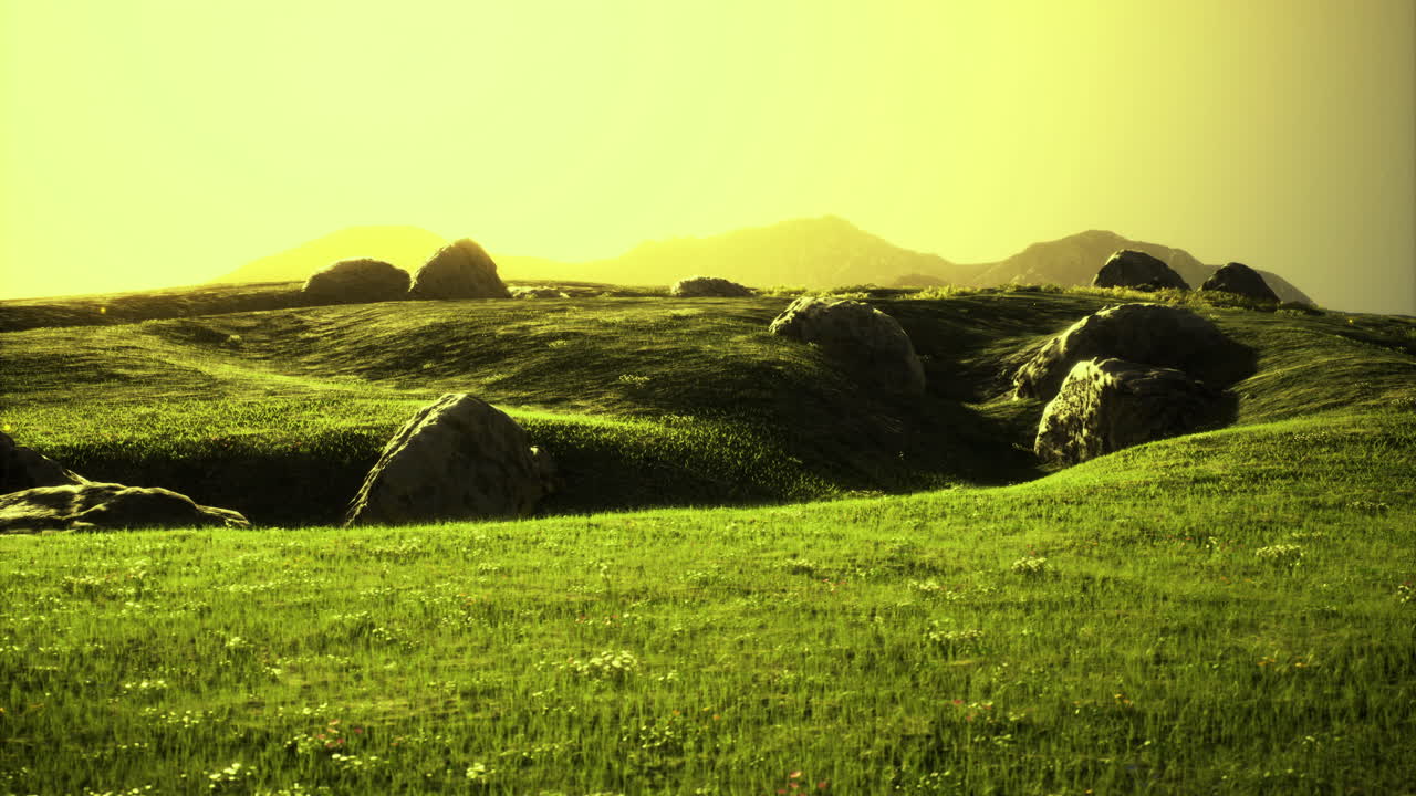 Vibrant green rolling hills under a soft golden sky at twilight