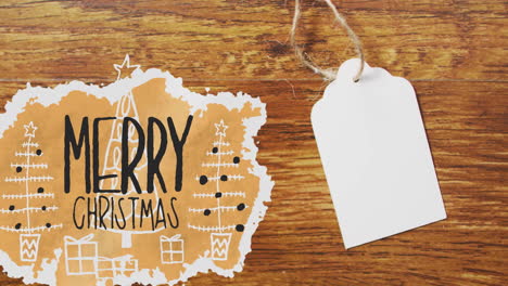 animation of merry christmas text over tag with copy space on wooden background
