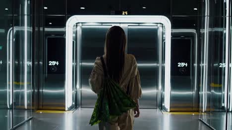 woman waiting in a modern elevator