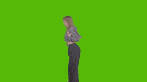 studio shot of young woman having fun dancing against green screen 34