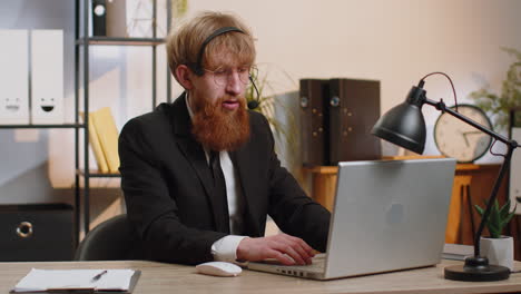 businessman working on laptop wearing headset, call center support service operator office helpline