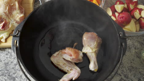 laying chicken in an oiled pot