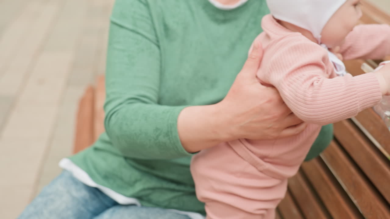 Child Reaches Toy, Young Child Extends Hand Toward Plaything Nearby, Infant Attempts To Grasp Toy With Help From Guardian, Young Child Reaches Out With Excitement For Toy While Supported By Parent