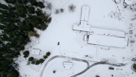 drone shot, top shot spinning and rising over snow covered place