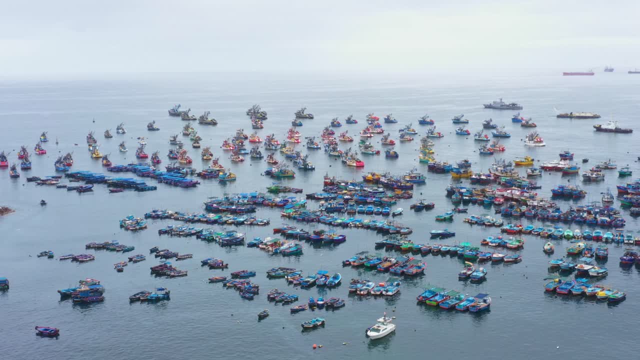AERIAL: Fishing boats sitting on the ocean