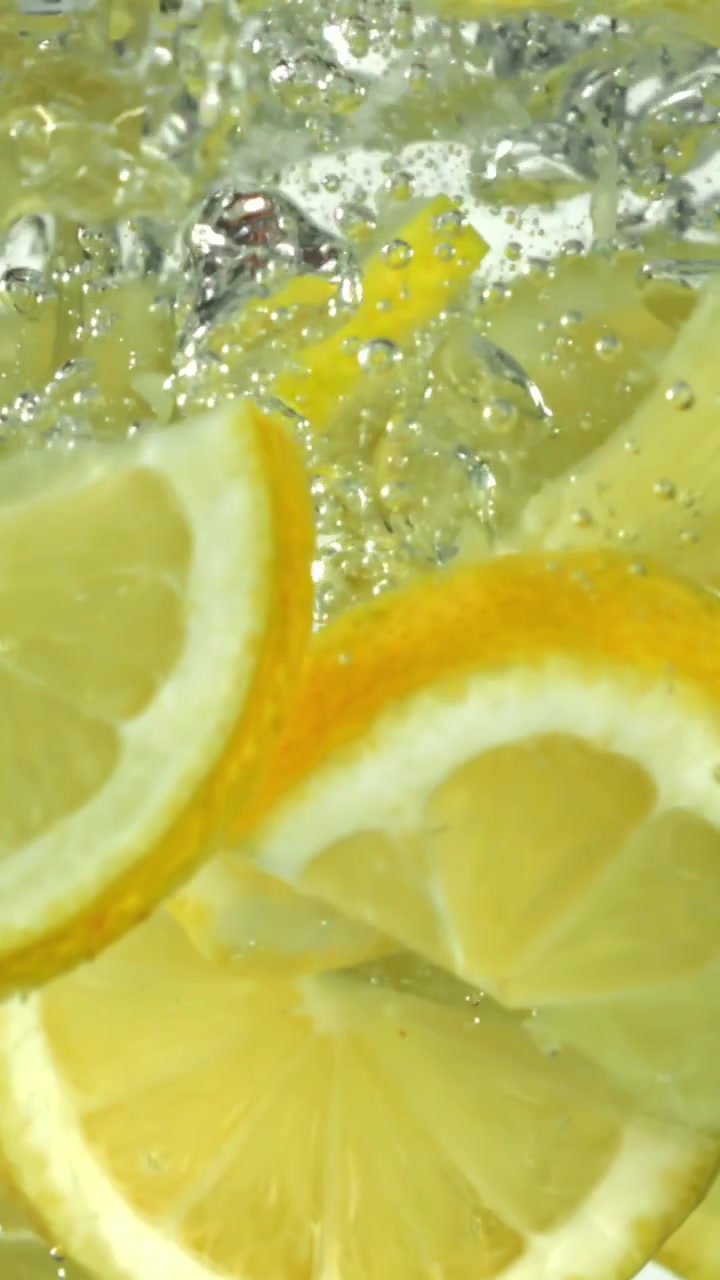 Lemon Slices Falling into Water with Bubbles in Slow Motion