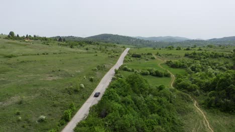 Drone-following-a-vehicle-movong-on-a-highways-in-the-highlands-going-to-the-place-of-Tsarichina-Hole-or-Area-51,-known-for-its-paranormal-sightings-in-Bulgaria