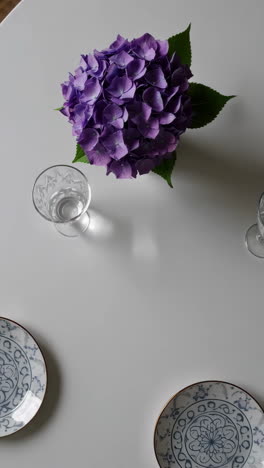 elegant table setting with purple hydrangea bouquet
