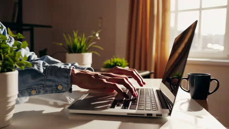 hands typing on a laptop