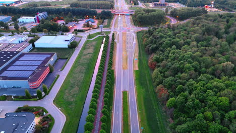 scenic dutch roads and nature. elevated perspective shows a busy road adjacent to lush greenery and tranquil water features in the netherlands
