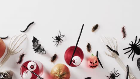 video of halloween skeleton hands, drinks and decorations with copy space on white background