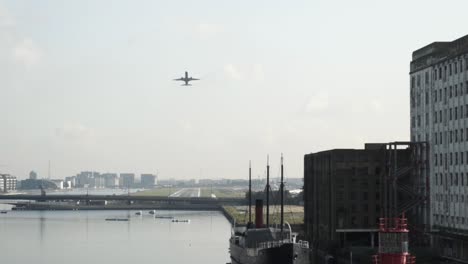 airplane over an industrial cityscapes