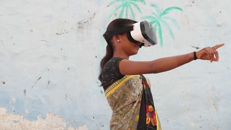 young teenager girl wearing vr virtual reality headset working games enjoy music playing engage cinema film hands point cutting edge contemporary wireless communication technology surreal india rural