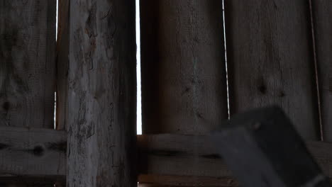 close up of old wooden barn wall texture with gaps of outside light