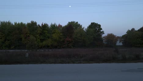 drone taking off with morning views of the autumn harvest moon