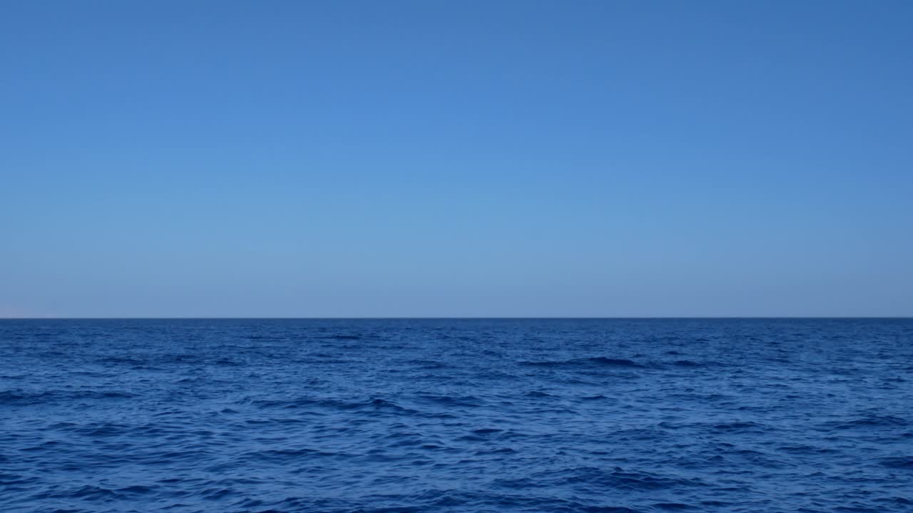 Blue transparent water surface on sea or ocean with small waves from the wind
