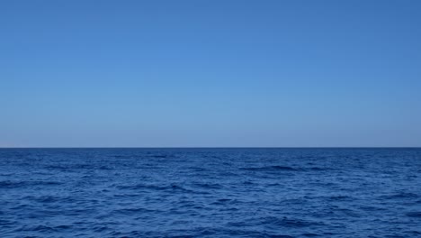 blue transparent water surface on sea or ocean with small waves from the wind