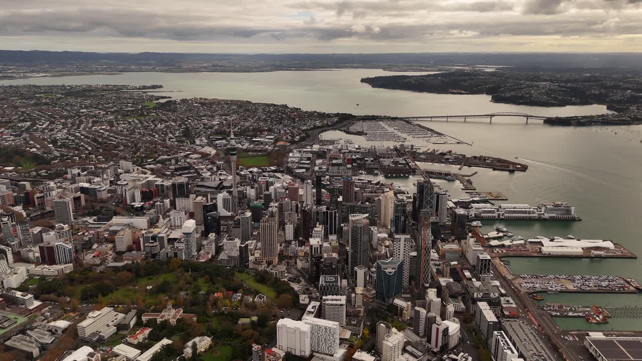 Vast 4K 60fps high-altitude panoramic view of the Auckland region. This epic aerial shot captures the city skyline, dual harbours, and the unique volcanic landscape from a bird's-eye perspective