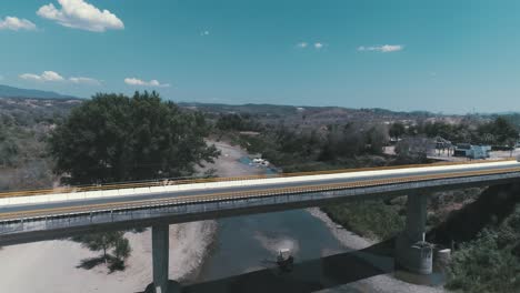 Aerial-shot-of-a-bridge-and-a-river-in-Badiraguato,-Sinaloa