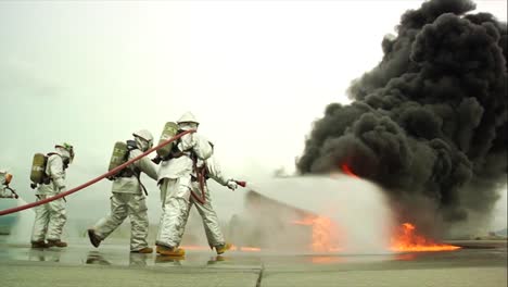 firefighters battle a raging chemical fire in a simulated airplane crash 13