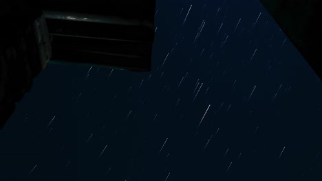 magical view of star trails time lapse shot under jet black sky at countryside