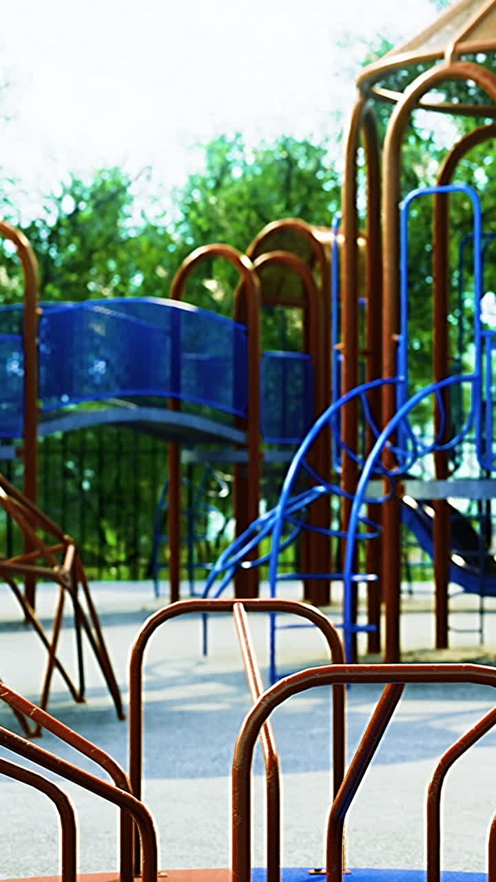 Colorful playground structure under the sun surrounded by greenery