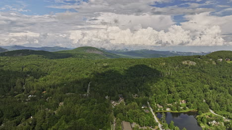 highlands north carolina aerial v14 reverse flyover capturing the landscape of rolling mountains covered in lush green foliages and secluded town center views - shot with mavic 3 cine - july 2022