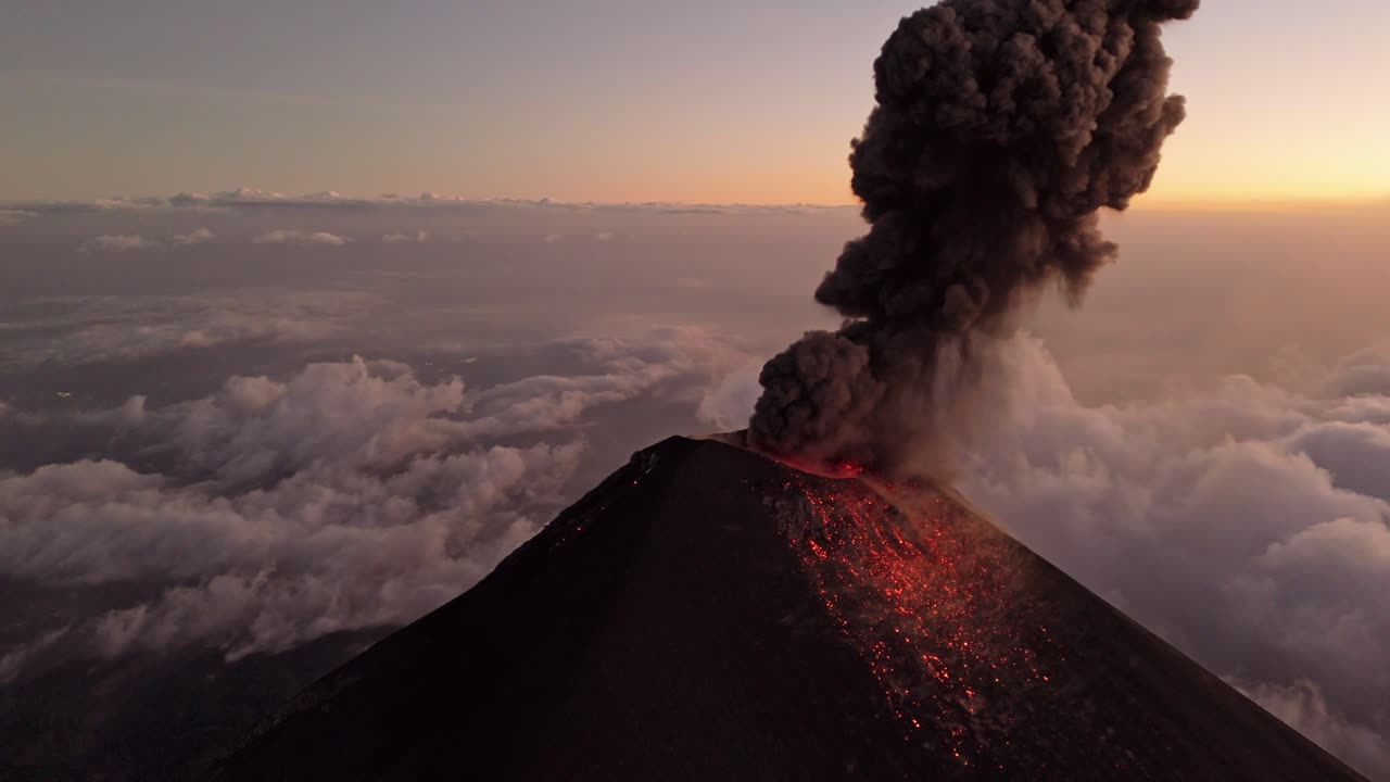 Guatemala active volcano eruption and spitting lava, aerial view