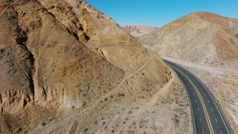 california state route 58 winding through the mojave desert's rugged canyons - descending aerial view