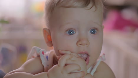 Cute-baby-girl-in-a-round-crib-staring-7