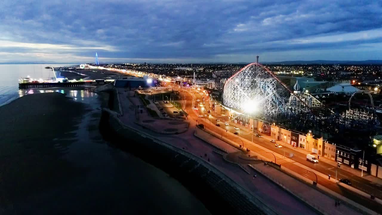 Drone shot flying down the promenade next to Blackpool pleasure beach