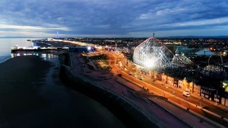 drone shot flying down the promenade next to blackpool pleasure beach